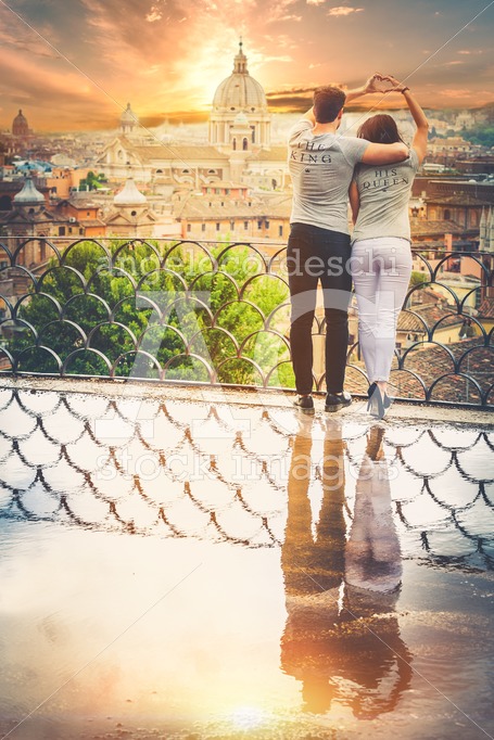 Beautiful pair embrace on a terrace with a reflection in a puddl - Angelo Cordeschi