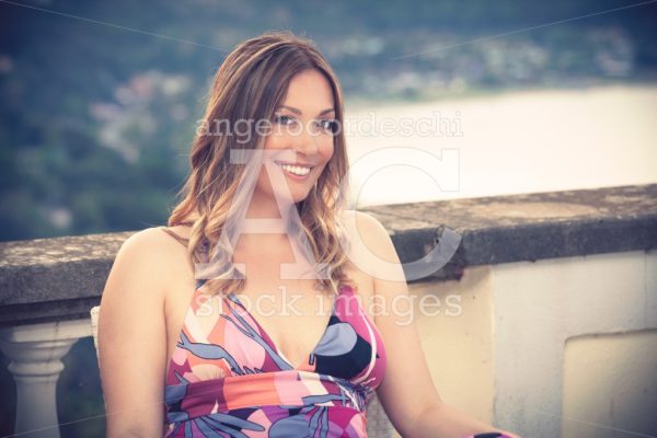 Beautiful Smiling Woman Sitting At The Restaurant. Angelo Cordeschi