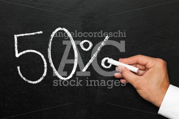 Fifty percent discount or increase. Blackboard with text in numbers 50% reduction or increase. - Angelo Cordeschi