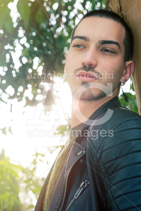 Handsome Young Man Leaning On A Tree. Natural Background In A Pa Angelo Cordeschi