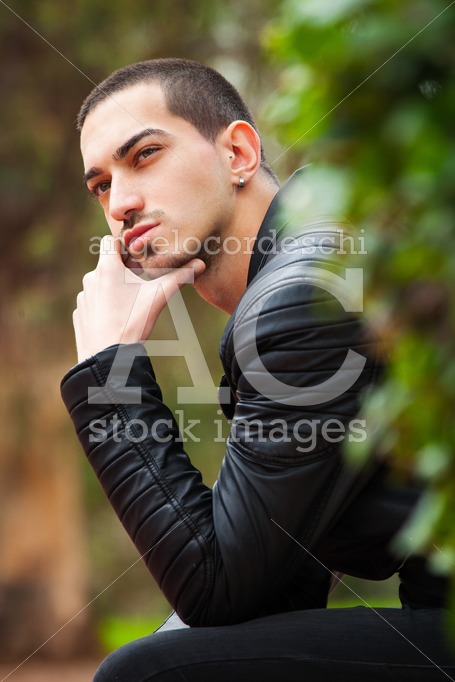 Handsome Young Man Sitting Thinking. Short Hair. A Thoughtful Ha Angelo Cordeschi