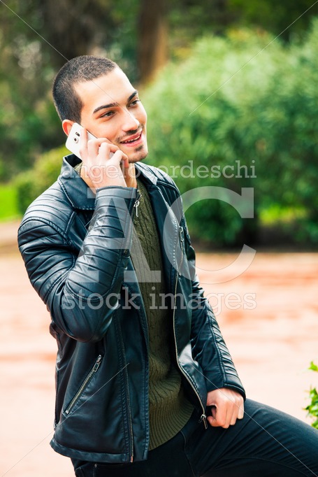Happy Young Man With Smart Phone. Talking On The Phone. A Young Angelo Cordeschi