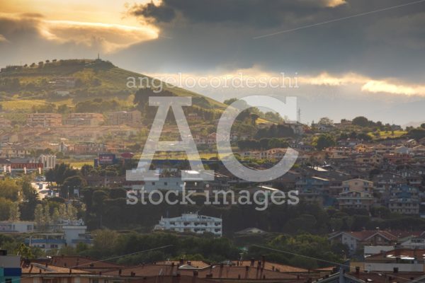 Idyllic Hilly Landscape With Houses And Cloudy Sky Over Sunset. Angelo Cordeschi