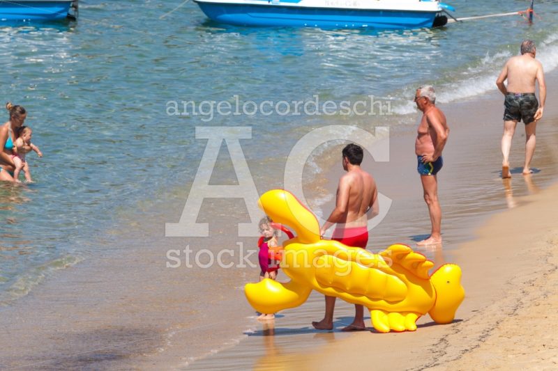 Procchio, Italy. June 26, 2016: Some People Are On The Shore Of Angelo Cordeschi