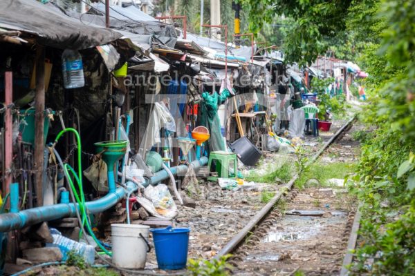 Row Of Shacks With Small Businesses Beside The Tracks Of A Train Angelo Cordeschi