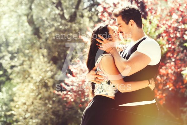 Young Couple Loving Outdoors In A Park. A Young Man And Young Wo Angelo Cordeschi