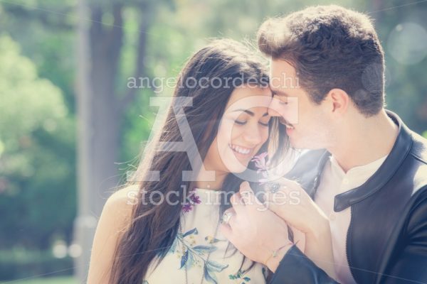 Young Couple Loving Outdoors In A Park. A Young Man And Young Wo Angelo Cordeschi